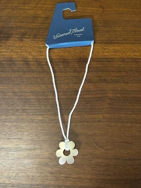 New Universal Thread necklace gold-tone metal flower pendant on rope cord.